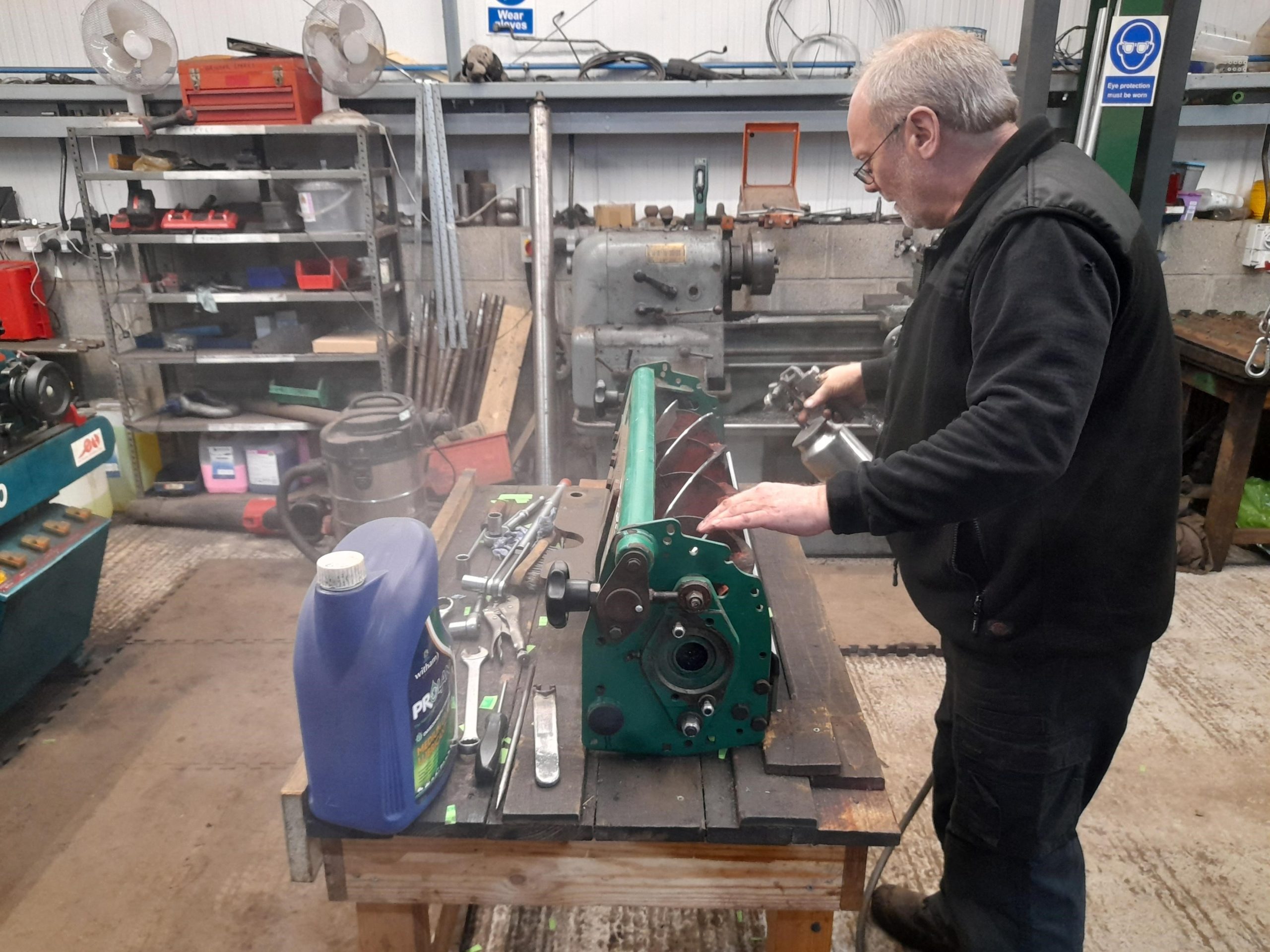 Prolan Medium Grade Lubricant being applied to mower blades after sharpening.